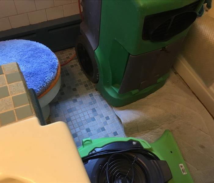 SERVPRO dehumidification equipment in a bathroom where the water damage took place