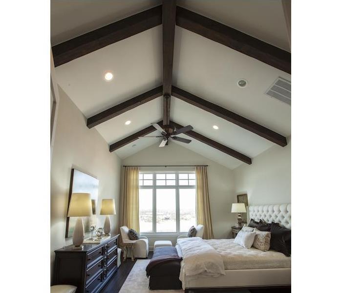 Bedroom with exposed wood beams on the ceilings 